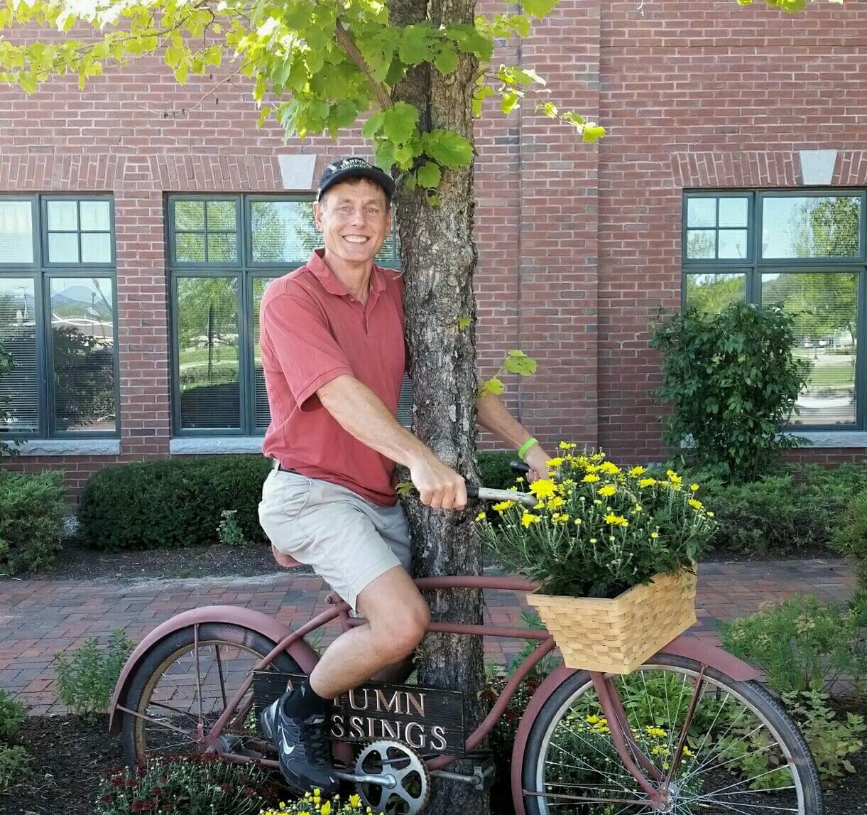 Barry posing on the vintage bicycle decorating the Bethel branch