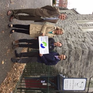 Group of people presenting check