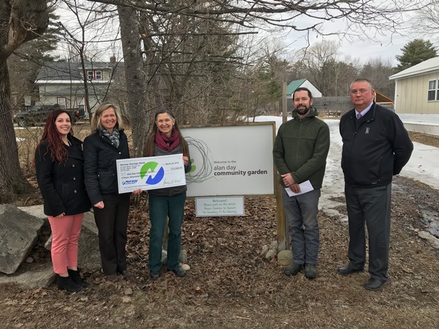 Group of 5 people at check presentation