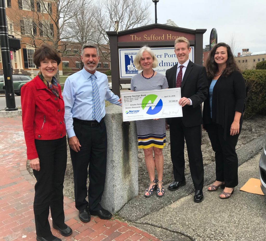 Group of people presenting large check.