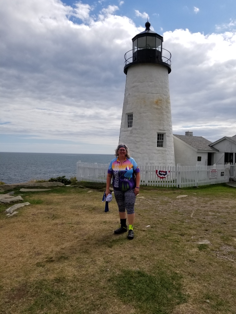 Woman in front of lighthouse