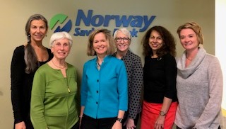 Group of women in front of Norway Savings Bank logo