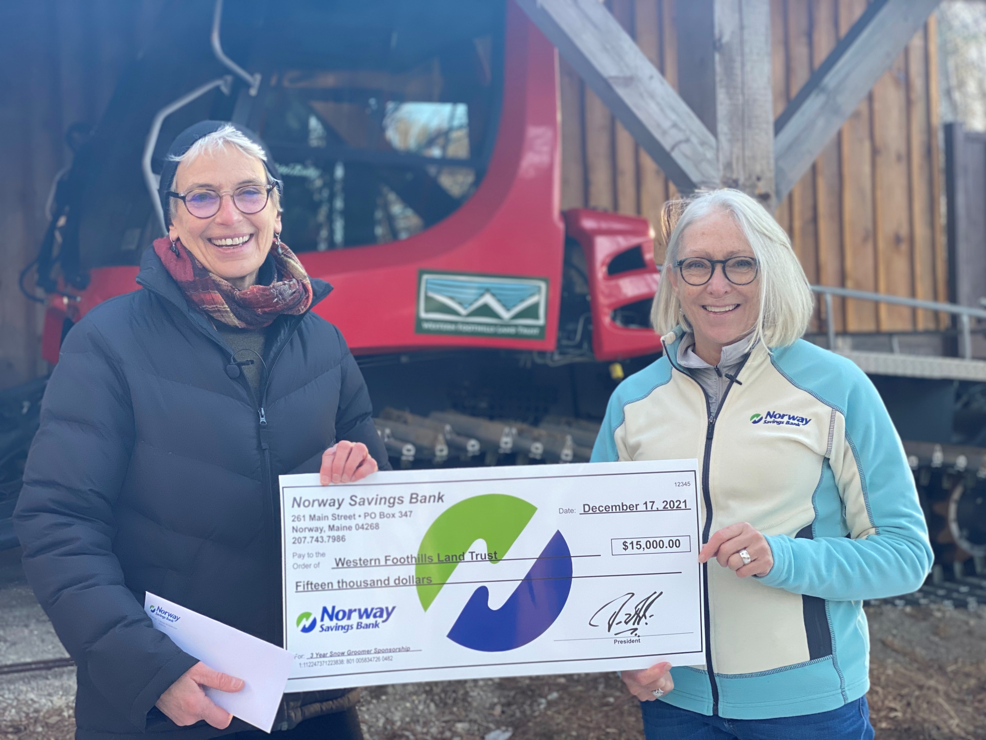 Two people holding an oversized check