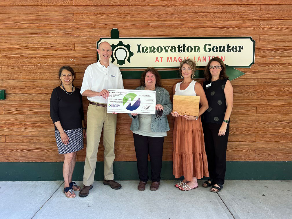 Group of people presenting a check