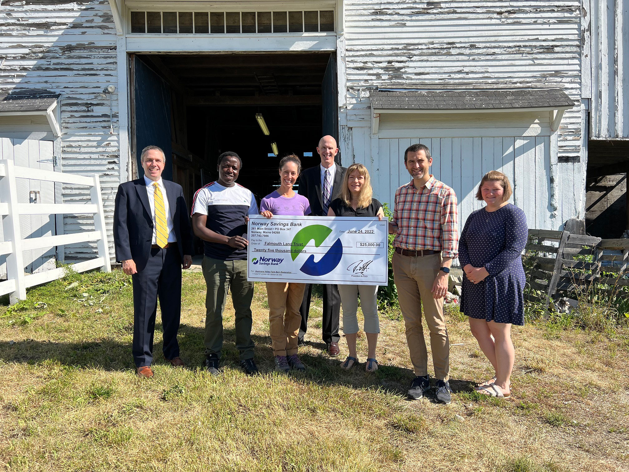 Group of people presenting a check