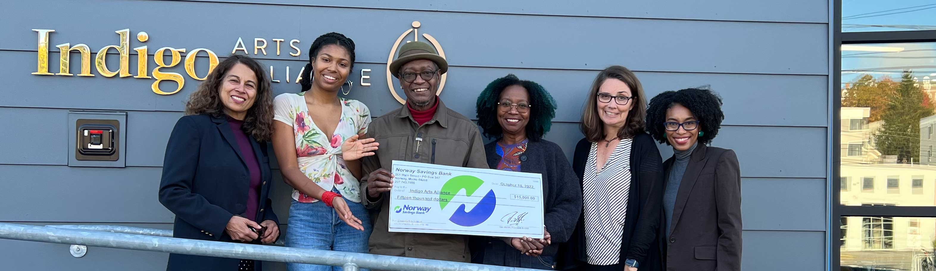 NSB employees present check to Indigo Arts Alliance members