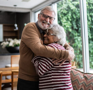 Happy elder couple hugging and happy to use asset management group services at norway savings