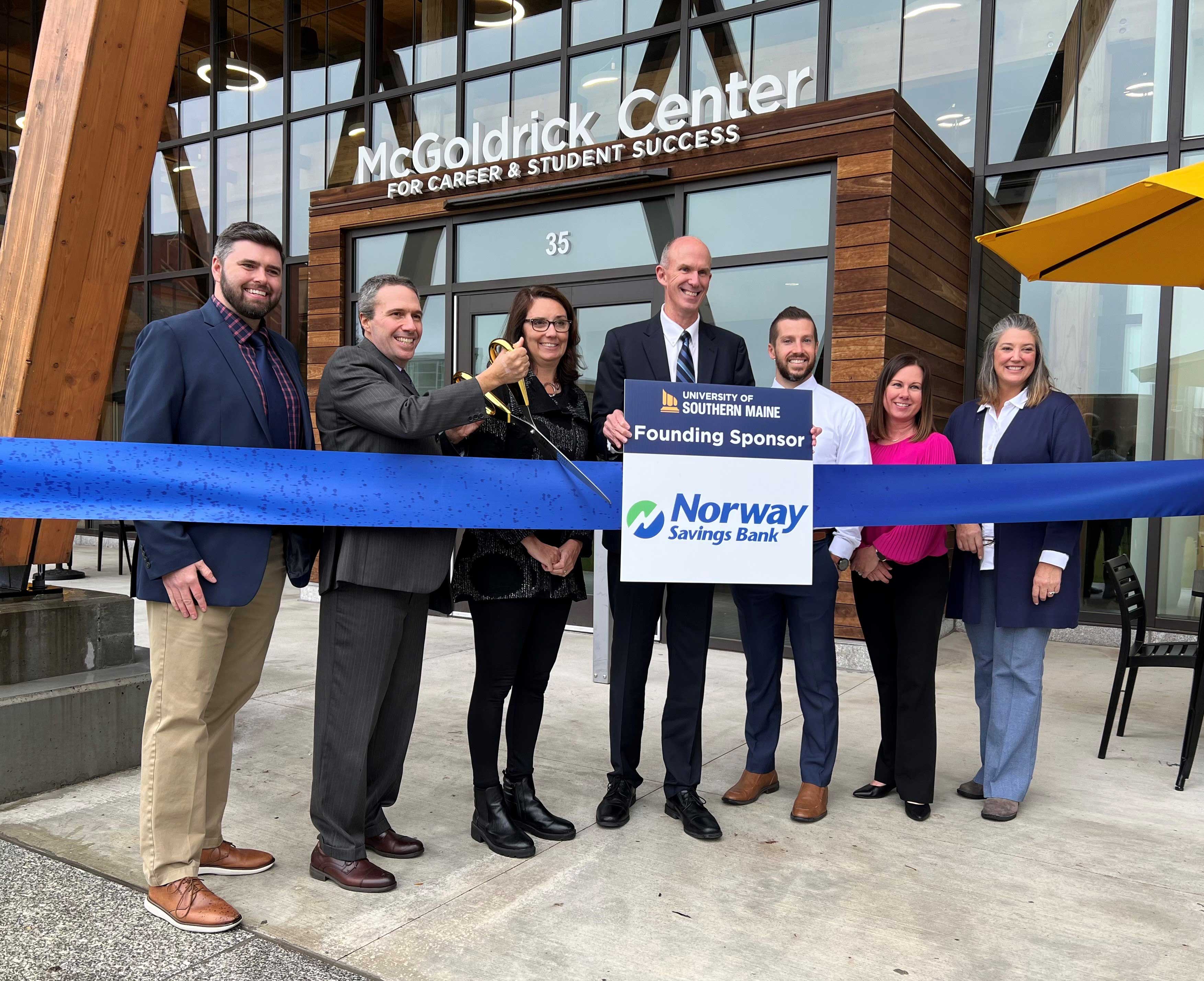 Group of NSB employees cutting the ribbon across new USM career and student success center